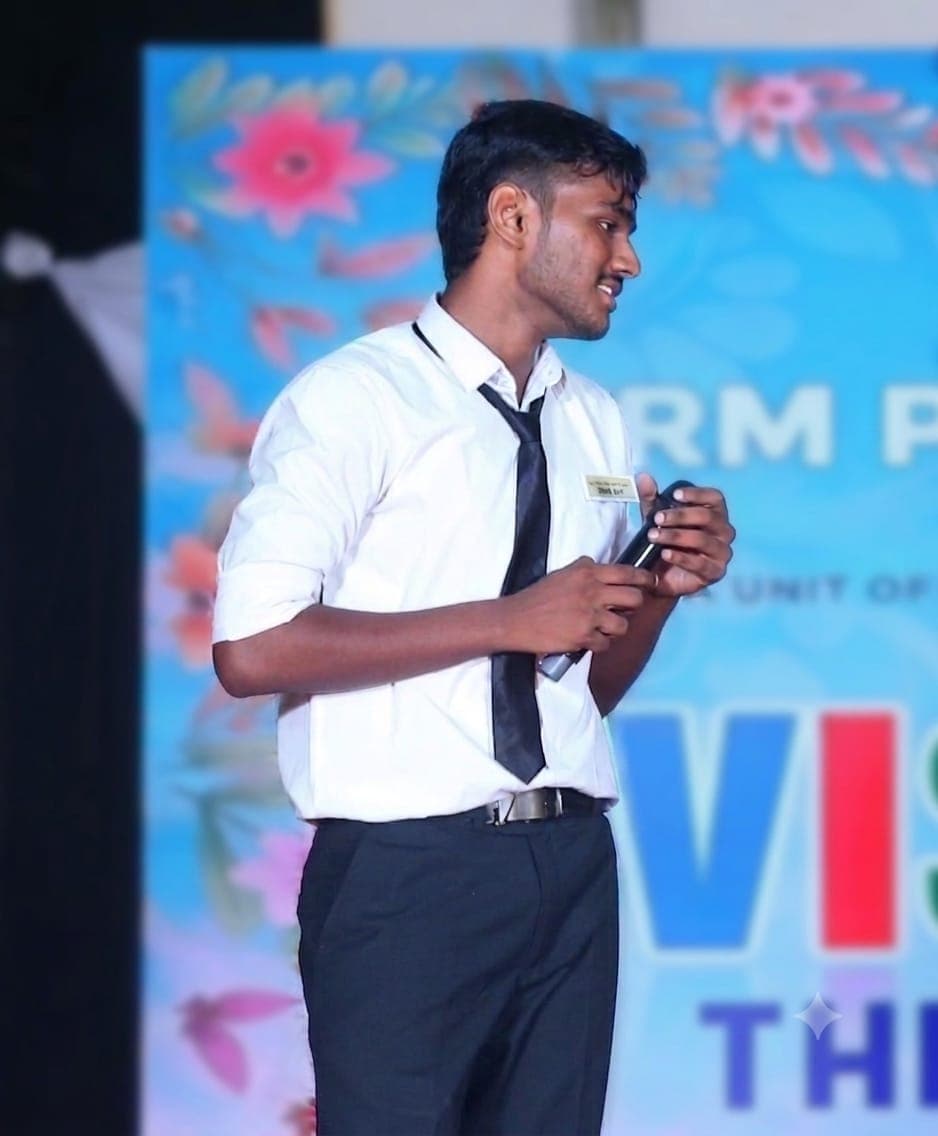 D Premsankar speaking on stage with a microphone